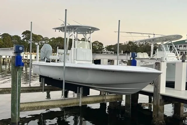  Yacht Photos Pics 2025 Contender 26 Bay boat docked at marina, side view.
