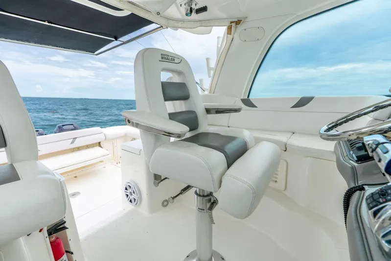 Reel Blessing Yacht Photos Pics 2012 Boston Whaler 345 Conquest helm with ocean view, featuring comfortable seating and steering wheel.