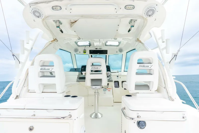 Reel Blessing Yacht Photos Pics 2012 Boston Whaler 345 Conquest cockpit with dual seats, ocean view, and modern controls.