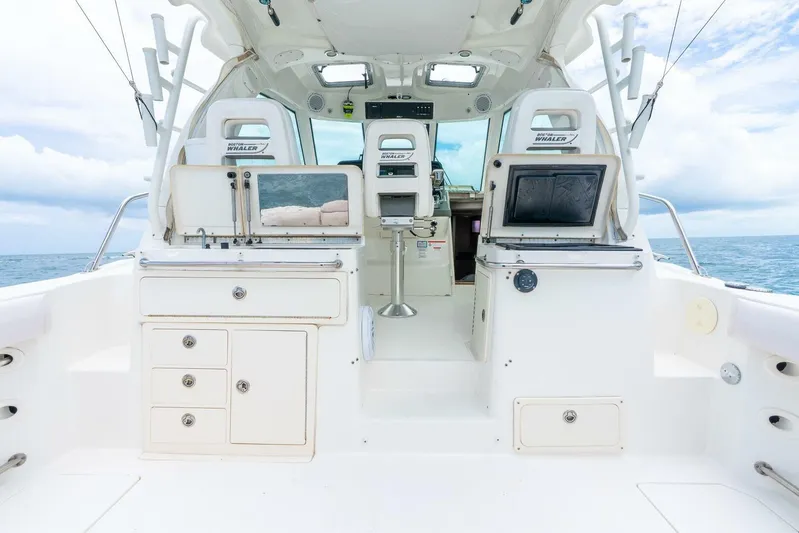 Reel Blessing Yacht Photos Pics 2012 Boston Whaler 345 Conquest boat interior with fishing equipment and ocean view.