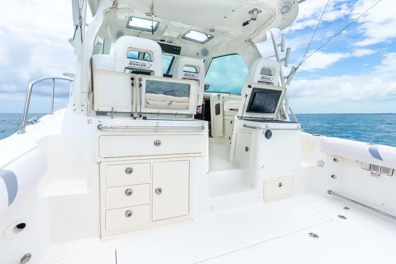 Reel Blessing Yacht Photos Pics 2012 Boston Whaler 345 Conquest boat interior with ocean view, featuring seating and storage.