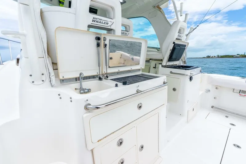 Reel Blessing Yacht Photos Pics 2012 Boston Whaler 345 Conquest boat interior with fishing station and ocean view.
