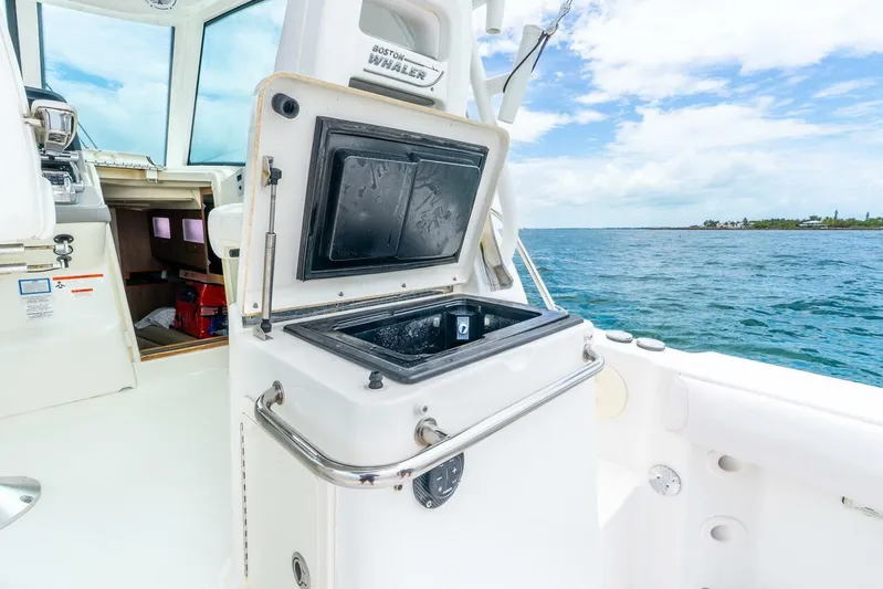 Reel Blessing Yacht Photos Pics 2012 Boston Whaler 345 Conquest interior with open storage compartment, ocean view.