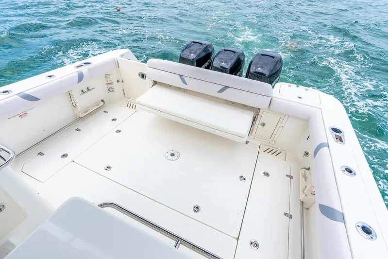 Reel Blessing Yacht Photos Pics 2012 Boston Whaler 345 Conquest boat deck with triple outboard engines on ocean.