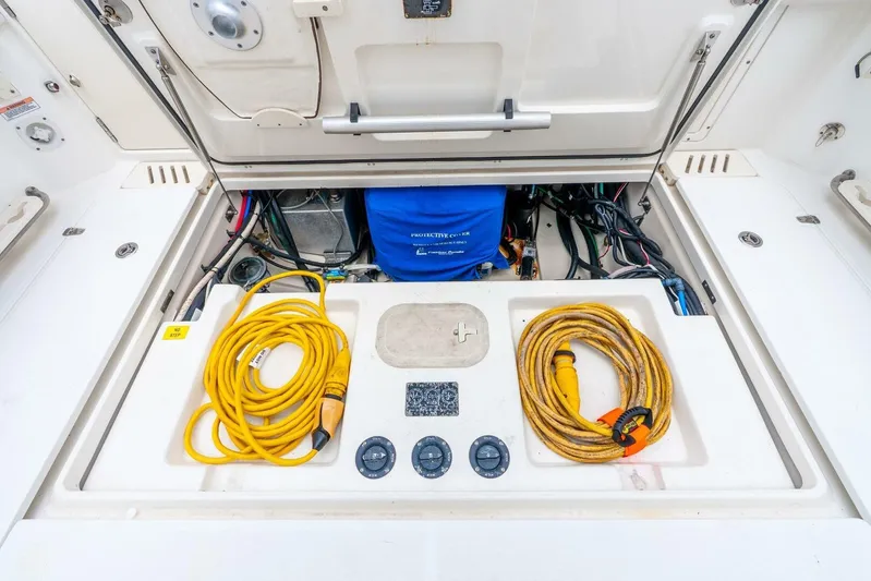Reel Blessing Yacht Photos Pics 2012 Boston Whaler 345 Conquest engine compartment with cables and equipment.