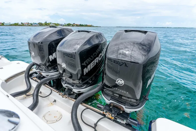 Reel Blessing Yacht Photos Pics Triple Mercury outboard engines on a 2012 Boston Whaler 345 Conquest in clear blue water.