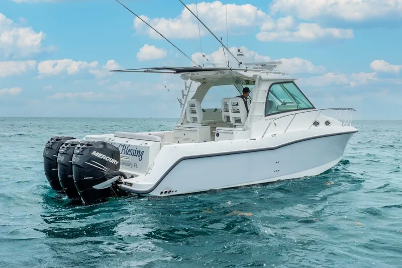 Reel Blessing Yacht Photos Pics 2012 Boston Whaler 345 Conquest boat on open water with triple Mercury engines.