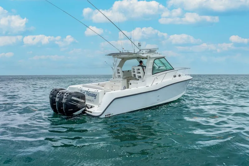 Reel Blessing Yacht Photos Pics 2012 Boston Whaler 345 Conquest boat on open sea under blue sky.