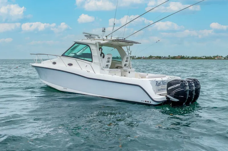 Reel Blessing Yacht Photos Pics 2012 Boston Whaler 345 Conquest boat on open water with triple Mercury engines.