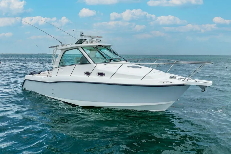 Reel Blessing Yacht Photos Pics 2012 Boston Whaler 345 Conquest boat cruising on open water under a clear sky.