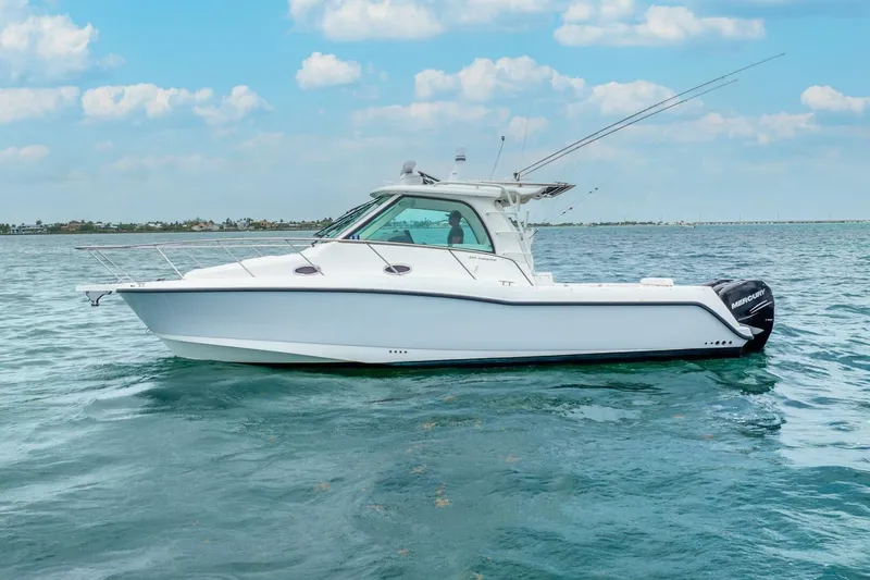 Reel Blessing Yacht Photos Pics 2012 Boston Whaler 345 Conquest boat on calm ocean waters under a blue sky.