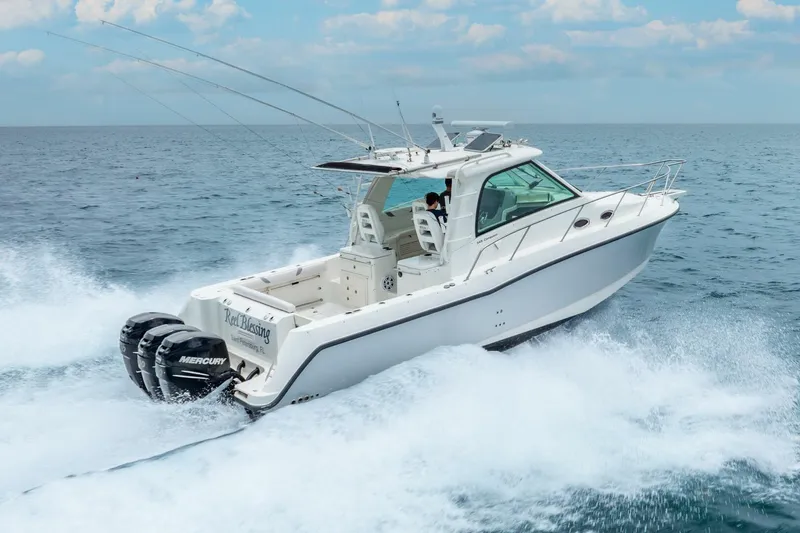 Reel Blessing Yacht Photos Pics 2012 Boston Whaler 345 Conquest cruising on open water with twin Mercury engines.