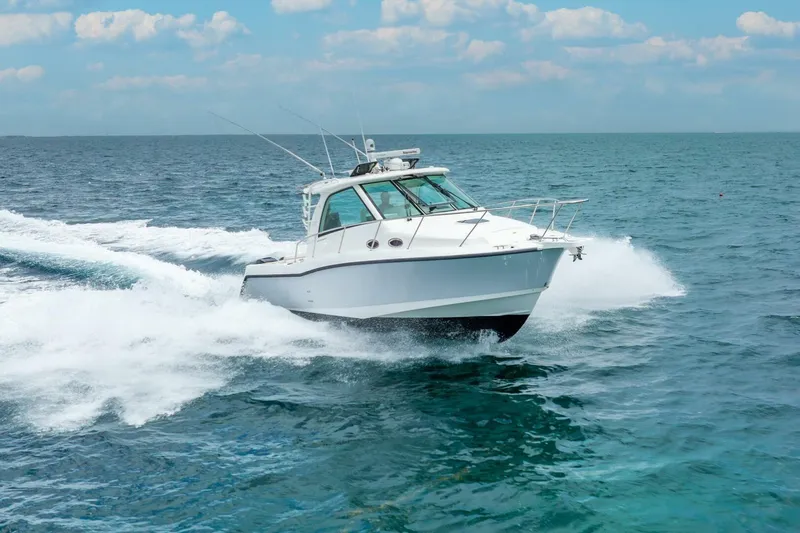 Reel Blessing Yacht Photos Pics 2012 Boston Whaler 345 Conquest cruising on open ocean waters.