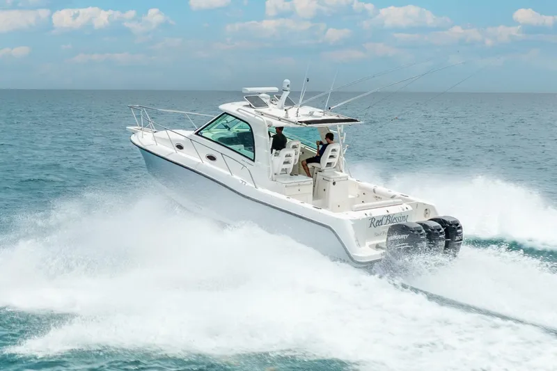 Reel Blessing Yacht Photos Pics 2012 Boston Whaler 345 Conquest cruising on open water, showcasing powerful engines.