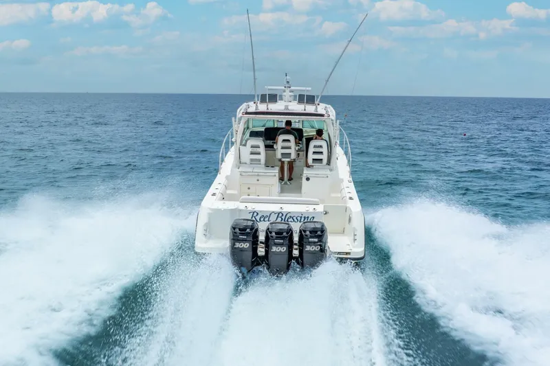 Reel Blessing Yacht Photos Pics 2012 Boston Whaler 345 Conquest cruising on open sea with triple engines.