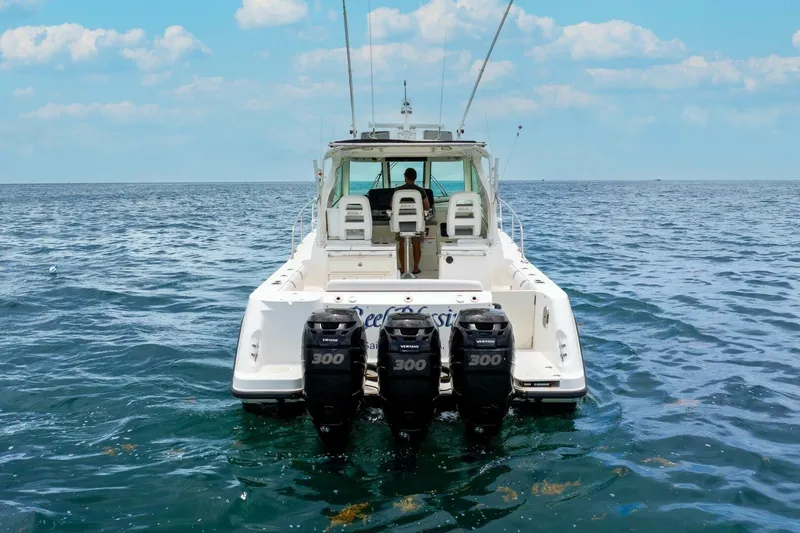 Reel Blessing Yacht Photos Pics 2012 Boston Whaler 345 Conquest boat on open sea with triple engines.