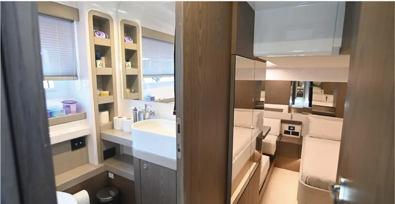  Yacht Photos Pics Luxurious interior of 2022 Ferretti Yachts 550, featuring modern bathroom and cozy cabin.