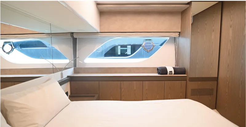  Yacht Photos Pics Luxurious bedroom interior of 2022 Ferretti Yachts 550, featuring modern design and elegant wood finishes.
