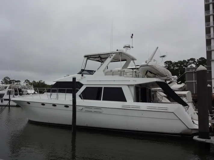 Gypsy Soul Yacht Photos Pics 1998 Navigator 53 Classic yacht docked at marina under cloudy skies.