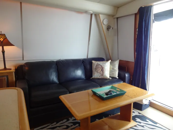 Gypsy Soul Yacht Photos Pics Luxurious 1998 Navigator 53 Classic yacht interior with leather sofa and wooden table.