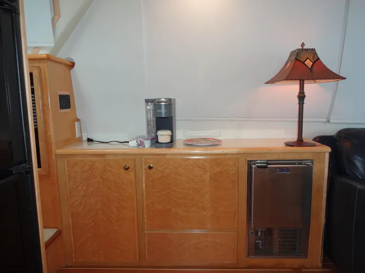 Gypsy Soul Yacht Photos Pics 1998 Navigator 53 Classic yacht interior with wooden cabinetry, lamp, and Keurig coffee maker.