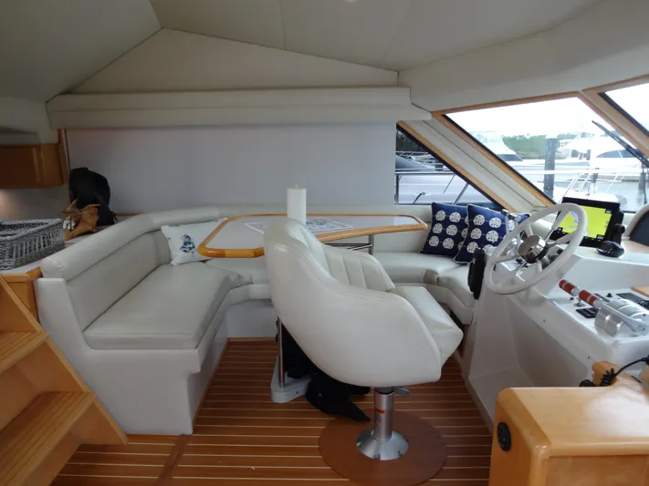 Gypsy Soul Yacht Photos Pics Interior of 1998 Navigator 53 Classic yacht with helm, seating, and wooden flooring.