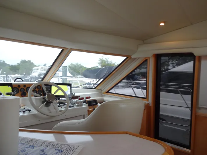 Gypsy Soul Yacht Photos Pics Interior view of 1998 Navigator 53 Classic yacht cockpit with steering wheel and navigation equipment.