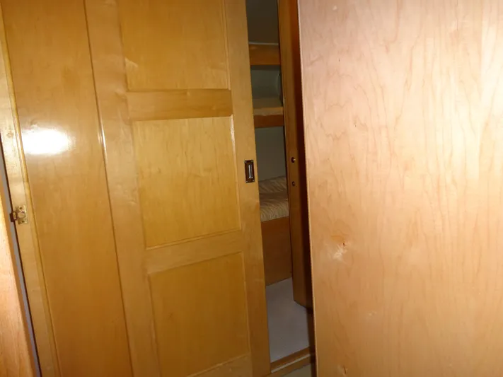 Gypsy Soul Yacht Photos Pics Wooden interior of 1998 Navigator 53 Classic yacht, featuring a sliding door and bunk beds.