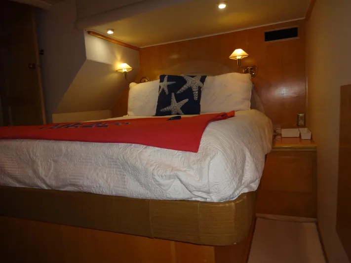 Gypsy Soul Yacht Photos Pics Cozy bedroom in 1998 Navigator 53 Classic yacht with starfish pillow and warm lighting.