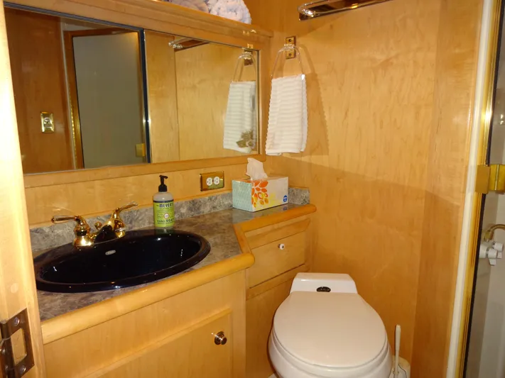 Gypsy Soul Yacht Photos Pics Luxurious bathroom in 1998 Navigator 53 Classic yacht with wood finish and modern fixtures.