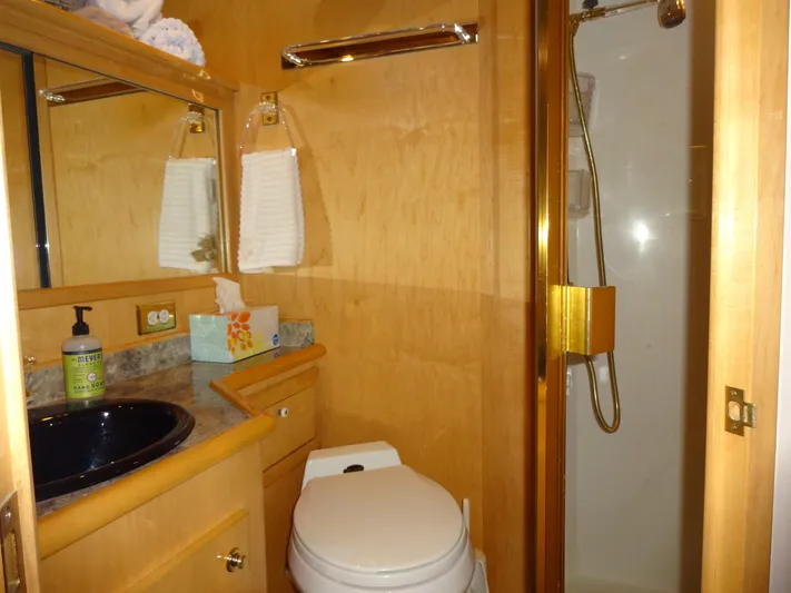 Gypsy Soul Yacht Photos Pics Luxurious bathroom in 1998 Navigator 53 Classic yacht with shower, sink, and toilet.
