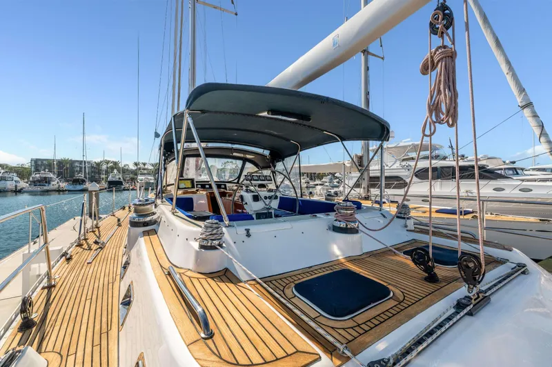Perfect Symmetry Yacht Photos Pics Luxury 2006 Hylas 70 yacht with teak deck in marina setting.