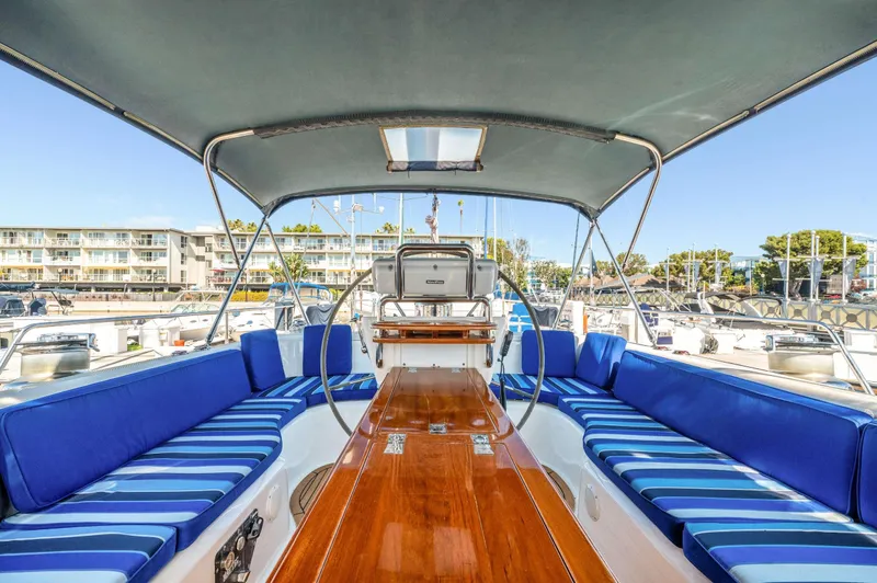 Perfect Symmetry Yacht Photos Pics Luxurious 2006 Hylas 70 yacht interior with blue seating and polished wood table.