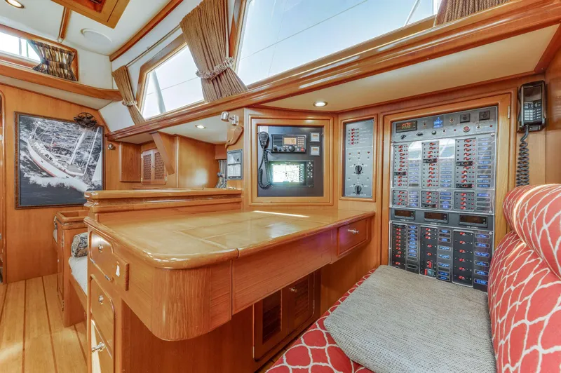 Perfect Symmetry Yacht Photos Pics Luxurious interior of a 2006 Hylas 70 yacht with wood paneling and control panels.