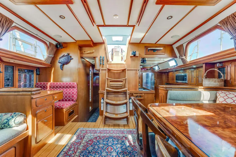 Perfect Symmetry Yacht Photos Pics Luxurious 2006 Hylas 70 yacht interior with elegant wood finish and cozy seating.