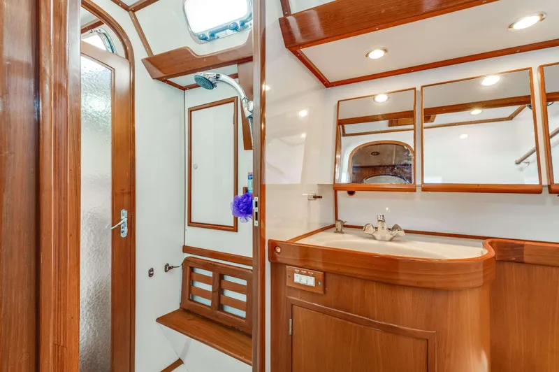 Perfect Symmetry Yacht Photos Pics Luxurious 2006 Hylas 70 yacht bathroom with wood accents and modern fixtures.