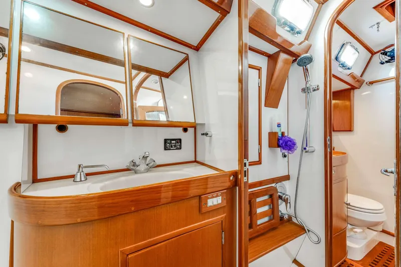 Perfect Symmetry Yacht Photos Pics Luxurious bathroom in 2006 Hylas 70 yacht with wood accents and modern fixtures.