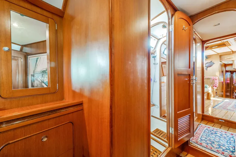 Perfect Symmetry Yacht Photos Pics Luxurious wooden interior of 2006 Hylas 70 yacht, featuring elegant cabinetry and spacious design.