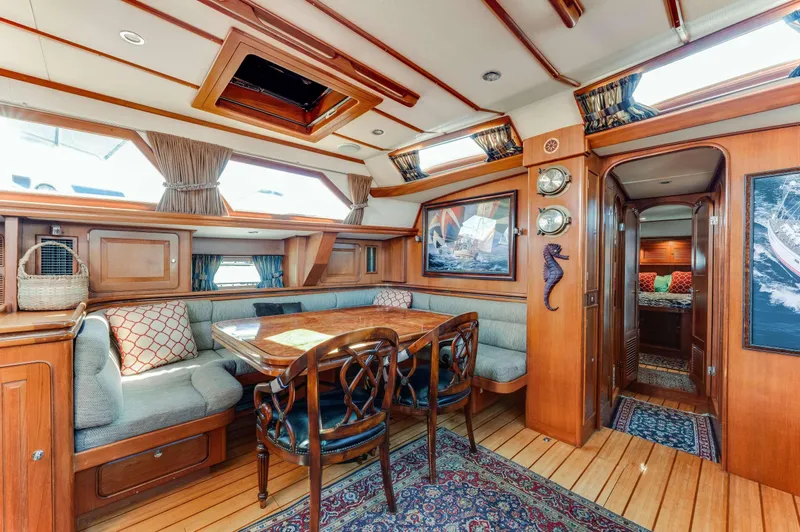 Perfect Symmetry Yacht Photos Pics Luxurious 2006 Hylas 70 yacht interior with elegant wood finish and cozy seating area.