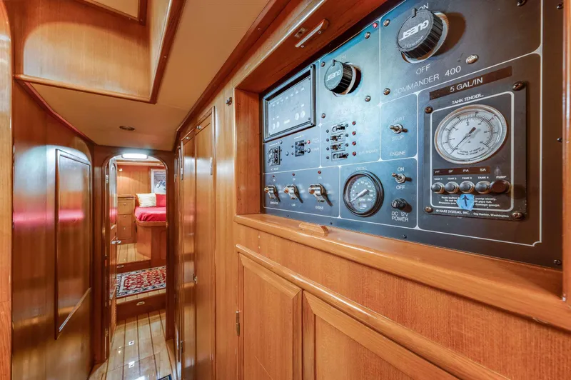 Perfect Symmetry Yacht Photos Pics Interior of 2006 Hylas 70 yacht, featuring control panel and wooden cabinetry.