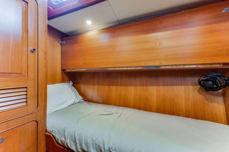Perfect Symmetry Yacht Photos Pics Cozy wooden cabin interior of 2006 Hylas 70 yacht with single bed.