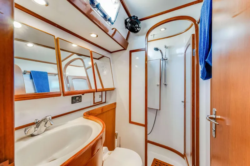 Perfect Symmetry Yacht Photos Pics Luxurious bathroom in 2006 Hylas 70 yacht with shower and wooden accents.