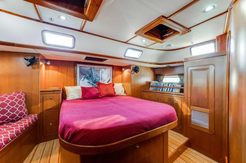 Perfect Symmetry Yacht Photos Pics Luxurious 2006 Hylas 70 yacht cabin with cozy bed and wooden interior.
