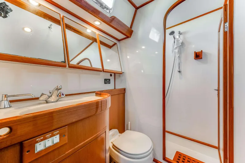 Perfect Symmetry Yacht Photos Pics Luxurious bathroom in 2006 Hylas 70 yacht with wooden accents and modern fixtures.