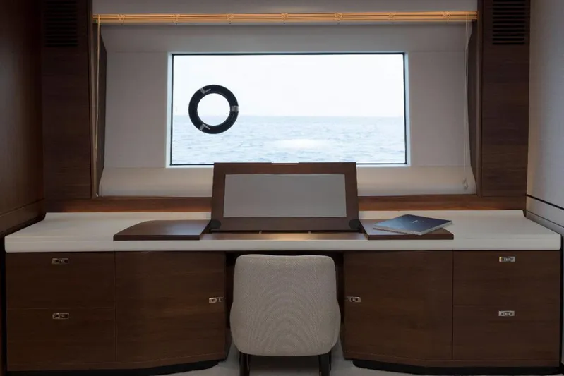  Yacht Photos Pics Luxurious desk area on Princess Y75 yacht, 2020 model, with ocean view through window.
