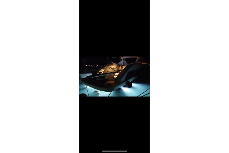  Yacht Photos Pics 2005 Sea Ray 425 Sundancer yacht illuminated at night with underwater lights.