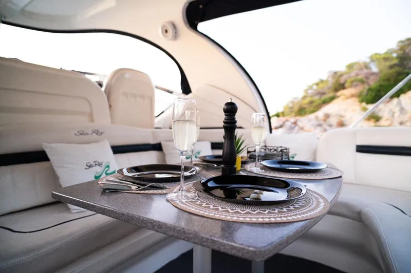  Yacht Photos Pics Luxurious dining setup on a 2005 Sea Ray 425 Sundancer yacht, featuring elegant tableware.