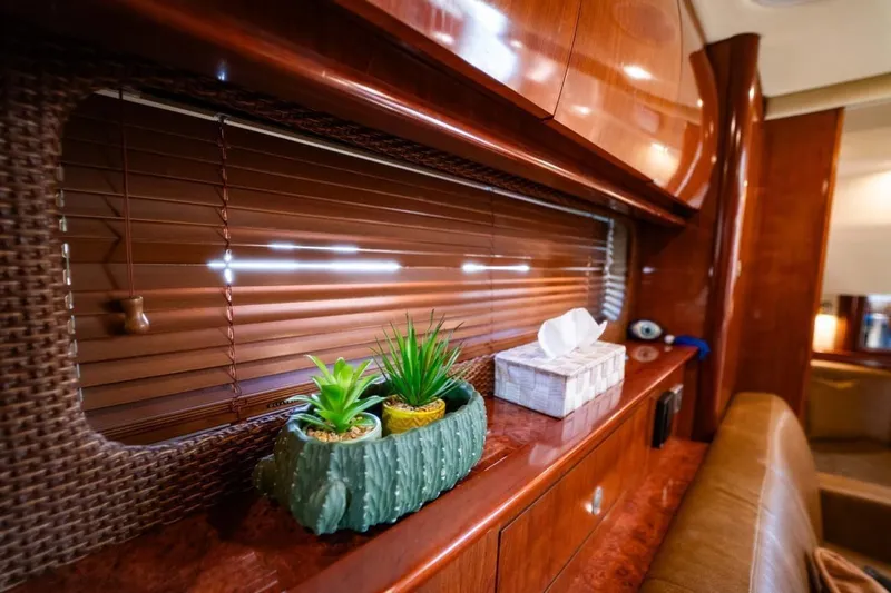  Yacht Photos Pics Interior of 2005 Sea Ray 425 Sundancer with wooden cabinetry and decorative plants.