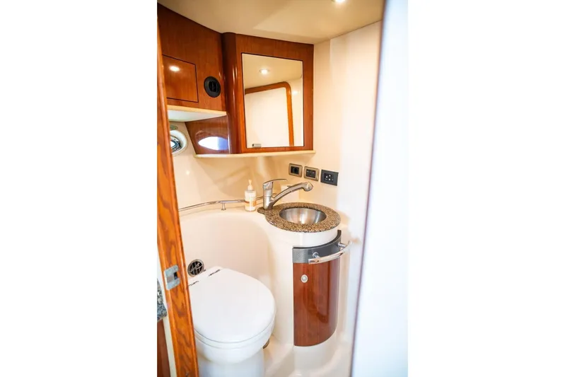  Yacht Photos Pics Luxurious bathroom in 2005 Sea Ray 425 Sundancer yacht with modern fixtures and wood accents.