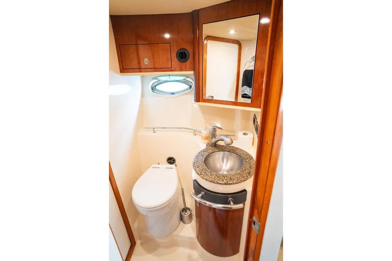  Yacht Photos Pics Luxurious bathroom in 2005 Sea Ray 425 Sundancer yacht with modern fixtures and wood accents.